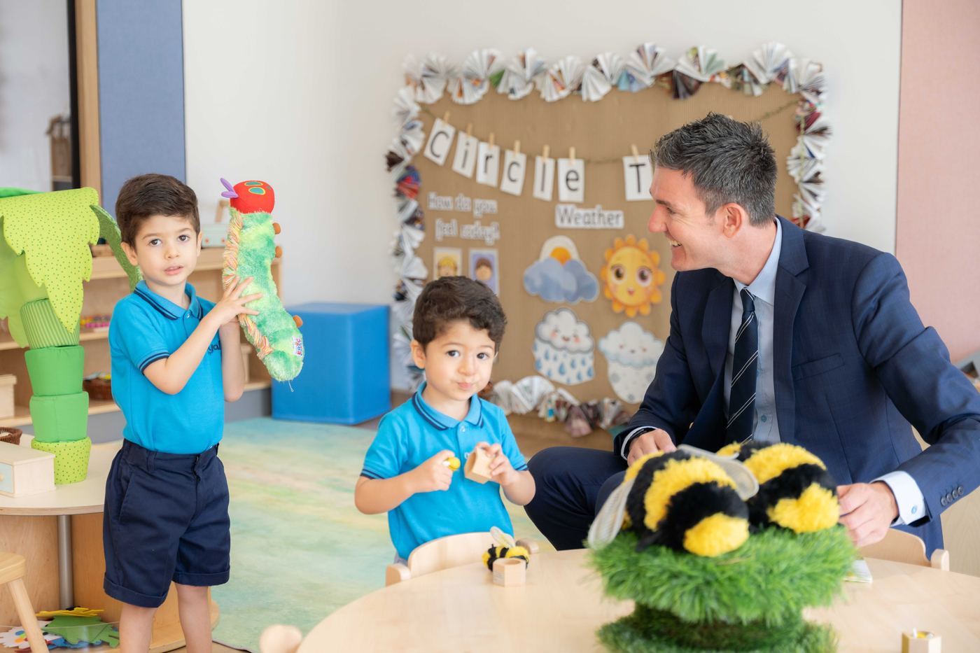 Alistair Downs, Founding Principal, with children in an Early Years classroom